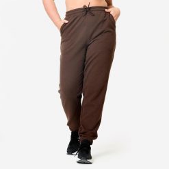 Spodnie dresowe damskie Domyos Gym & Pilates. Brązowe spodnie sportowe DOMYOS, m, bez wzorów, z bawełny, na fitness i siłownię. Za 89.99 zł.