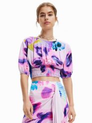 Desigual Bluzka MONSIEUR CHRISTIAN LACROIX Rina 23SWBW15 Fioletowy Regular Fit. Fioletowe bluzki Desigual, l, bez wzorów, z wiskozy, bez kołnierzyka, bez ramiączek. Za 129.99 zł.