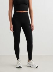 Damskie legginsy z wysokim stanem, odprowadzające pot Sculpting czarne. Czarne legginsy AIM'N, s, bez wzorów, z lycry, z podwyższonym stanem. Za 339.00 zł.