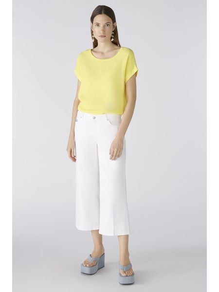 Oui Koszulka w kolorze żółtym rozmiar: 40. Żółte bluzki Oui, bez wzorów, z wiskozy, bez kołnierzyka, bez ramiączek. Za 82.99 zł.