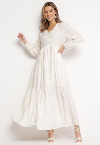 Jasnobeżowa Sukienka Pudełkowa Maxi Ozdobiona Przeszyciami i Guziczkami Kedora. Brązowe sukienki Born2be, na jesień, l, bez wzorów, bez kołnierzyka, bez ramiączek, maxi, rozkloszowane. Za 59.99 zł.