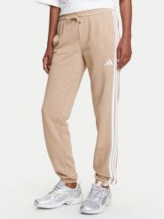 Adidas Spodnie dresowe Essentials 3-Stripes JX7661 Beżowy Regular Fit. Brązowe spodnie dresowe Adidas, s, bez wzorów, z dresówki. Za 219.99 zł.