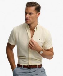 Superdry Koszula Preppy Oxford krótki rękaw Pastel Yellow Chambray. Żółte koszule Superdry, uniwersalny, bez wzorów, z bawełny, klasyczne, bez kołnierzyka, bez ramiączek. Za 301.95 zł.