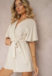 Beżowy Kopertowy Kombinezon z Bawełny Wiązany w Talii Materiałowym Paskiem Vikly. Brązowe sukienki Renee, na co dzień, l, bez wzorów, z bawełny, eleganckie, bez kołnierzyka, bez ramiączek, kopertowe. Za 74.99 zł.