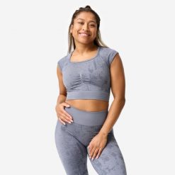 Koszulka fitness damska Domyos crop top seamless. Szare bluzki DOMYOS, s, bez wzorów, z materiału, sportowe, bez kołnierzyka, bez ramiączek. Za 89.99 zł.