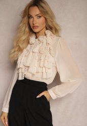 Beżowa Prześwitująca Koszula z Falbankami i Kwiatowym Zdobieniem przy Dekolcie Raivona. Brązowe koszule Renee, m, z aplikacjami, z jeansu, eleganckie, bez kołnierzyka, bez ramiączek. Za 134.99 zł.