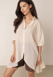 Beżowa Zwiewna Koszula Letnia Oversize z Bawełny o Nietoperzowym Kroju Canomela. Brązowe koszule Born2be, l, bez wzorów, z bawełny, eleganckie, bez kołnierzyka, bez ramiączek. Za 139.99 zł.
