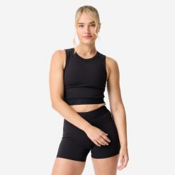 Koszulka fitness damska Domyos crop top. Czarne koszulki sportowe DOMYOS, bez wzorów, z elastanu, bez ramiączek, na fitness i siłownię. Za 69.99 zł.