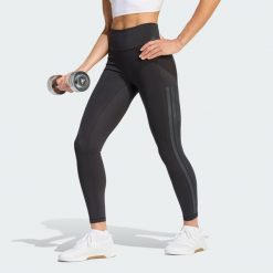 Legginsy Optime Workout 3-Stripes 7/8. Czarne legginsy Adidas, bez wzorów, ze skóry, z podwyższonym stanem. Za 279.00 zł.