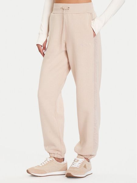 Guess Spodnie dresowe V5BB10 KB681 Beżowy Regular Fit. Brązowe spodnie dresowe Guess, l, z aplikacjami, z bawełny. Za 299.99 zł.