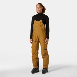 Damskie spodnie narciarskie na szelkach Helly Hansen Powderqueen. Brązowe spodnie narciarskie Helly Hansen, bez wzorów, narciarskie. W wyprzedaży za 1,208.00 zł.
