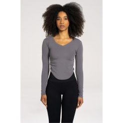 Koszulka fitness damska Gym Glamour wycięta z długimi rękawami. Szare bluzki GYM GLAMOUR, m, bez wzorów, glamour, bez kołnierzyka, bez ramiączek. Za 149.99 zł.