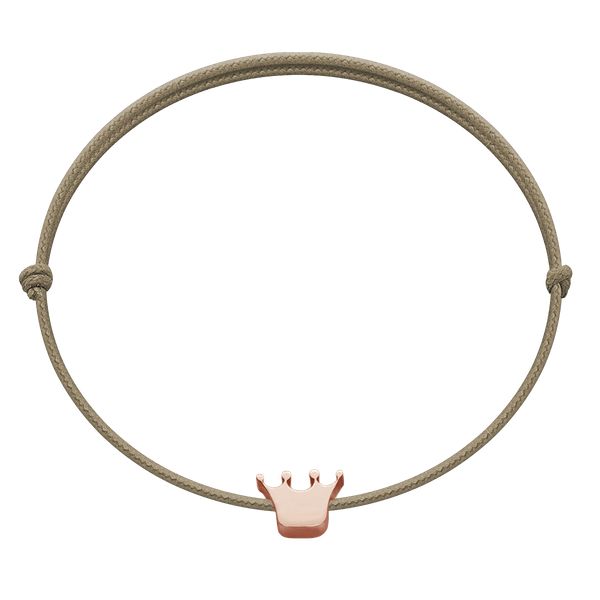 Bransoletka z koroną Etincelle, różowe pozłocenie, na cienkim sznurku w kolorze jasnego cappucino. Czerwone bransoletki Lilou, pozłacane. Za 79.00 zł.