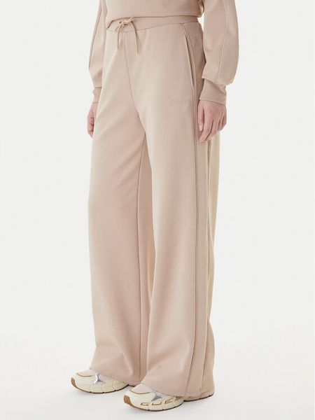 Guess Spodnie dresowe V5BB12 KCX22 Beżowy Regular Fit. Brązowe spodnie dresowe Guess, xxs, z aplikacjami, z dresówki. Za 479.99 zł.