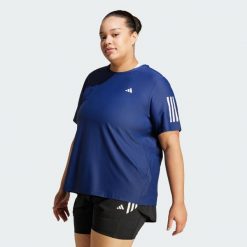 Koszulka Own The Run (Plus Size). Białe bluzki Adidas, plus size, bez wzorów, z materiału, sportowe, bez kołnierzyka, plus size, bez ramiączek. Za 159.00 zł.