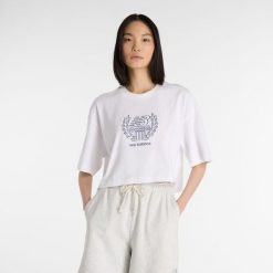 Koszulka damska New Balance WT51935WT – biała. Białe bluzki New Balance, xl, bez wzorów, z bawełny, bez kołnierzyka, bez ramiączek. Za 129.99 zł.