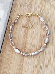 Nakkash Pozłacana bransoletka z masą perłową rozmiar: onesize. Brązowe bransoletki Nakkash, z perłą, pozłacane. Za 30.99 zł.