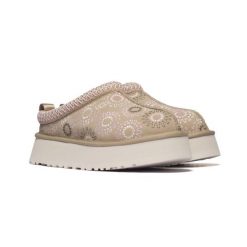 Damskie kapcie Ugg W TAZZ SUN STITCH 1178193-MDSD. Brązowe obuwie domowe UGG, bez wzorów, z gumy, z okrągłym noskiem, bez zapięcia. Za 519.00 zł.