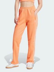 Adidas Spodnie dresowe w kolorze pomarańczowym rozmiar: XS. Pomarańczowe spodnie dresowe Adidas, xs, bez wzorów, z dresówki. Za 123.25 zł.