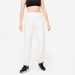 Spodnie dresowe damskie Domyos Gym & Pilates 500. Białe spodnie dresowe DOMYOS, m, bez wzorów, z bawełny, na fitness i siłownię. W wyprzedaży za 79.99 zł.
