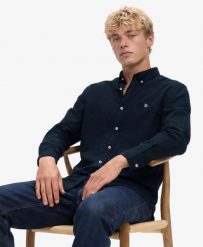 Superdry Klasyczna koszula Oxford z długim rękawem z bawełny organicznej. Niebieskie koszule Superdry, xl, bez wzorów, z bawełny, eleganckie, bez kołnierzyka, bez ramiączek. Za 323.85 zł.