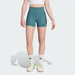Legginsy Optime 3-Stripes 1/4 Short. Niebieskie legginsy Adidas, bez wzorów, z materiału, krótkie. Za 199.00 zł.