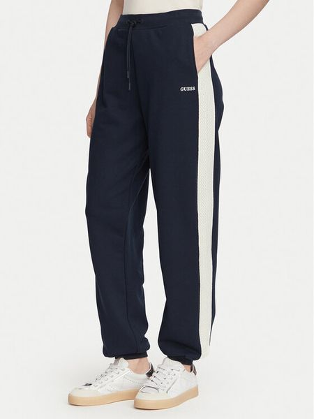 Guess Spodnie dresowe V6YB09 K4292 Granatowy Regular Fit. Niebieskie spodnie dresowe Guess, m, z aplikacjami, z dresówki. Za 355.99 zł.