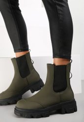 Zielone Botki Rhodima. Zielone botki Renee, bez wzorów, z nubiku, przed kolano, bez obcasa, na płaskiej podeszwie, bez zapięcia. Za 64.99 zł.