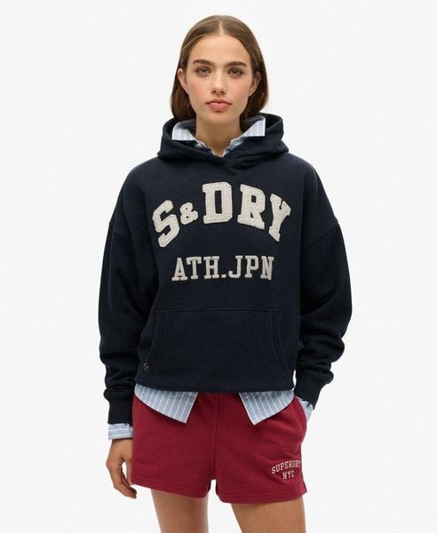 Bluza z kapturem Ath Ess Appliq Relaxed. Niebieskie bluzy Superdry, z aplikacjami, z bawełny, z kapturem. Za 292.10 zł.