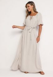 Jasnobeżowa Trapezowa Muślinowa Sukienka z Bawełny z Paskiem i Gumką w Talii Vimarinn. Brązowe sukienki Born2be, na co dzień, bez wzorów, z bawełny, bez kołnierzyka, bez ramiączek, maxi, proste. Za 149.99 zł.
