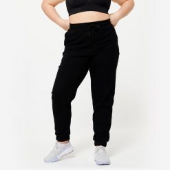 Spodnie dresowe damskie Domyos Gym & Pilates. Czarne spodnie dresowe DOMYOS, s, bez wzorów, z bawełny, na fitness i siłownię. Za 89.99 zł.