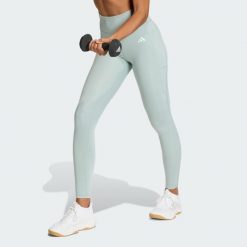 Długie legginsy Optimé Essentials Stash Pocket. Zielone legginsy Adidas, bez wzorów, z podwyższonym stanem, długie. Za 199.00 zł.