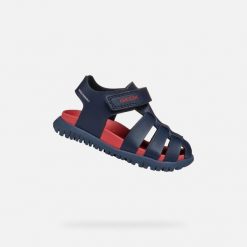 Sandały Geox Model B Sandal Fusbetto Bo Kolor Niebieski. Niebieskie sandały Geox, bez wzorów, z tkaniny, bez obcasa, bez zapięcia. Za 189.99 zł.
