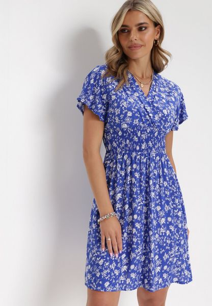 Granatowa Kwiecista Sukienka Mini z Wiskozy z Marszczoną Gumką w Pasie Catela. Niebieskie sukienki Born2be, na lato, l, bez wzorów, z wiskozy, bez kołnierzyka, bez ramiączek, mini, kopertowe. Za 59.99 zł.
